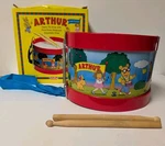 Vintage Arthur Schylling Tin Toy W/ Drumsticks Adjustable Strap 1998 Pbs. Fixed Price $34.99.