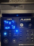 Alesis Nitro Max Kit With The Original Module, Kick Tower, Pedals, And Throne. Fixed Price $349.00.