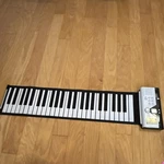 Roll-up Piano 49-KEY Portable Electronic Keyboard, Built-in Speaker, Black/white. Fixed Price $15.00.